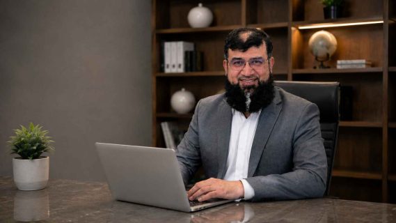 Usman sitting in office